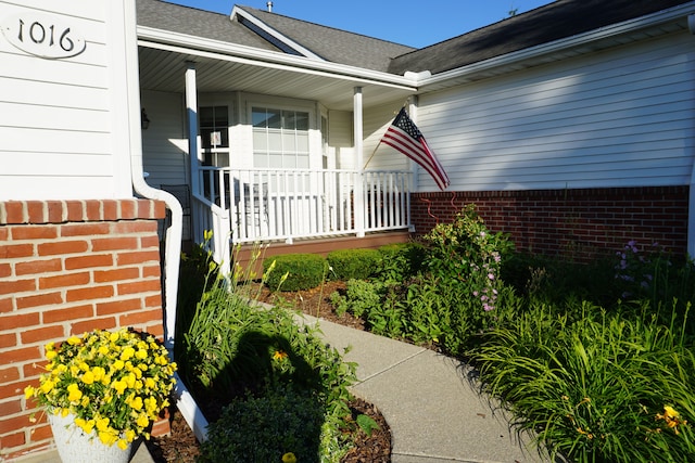 doorway to property featuring covered porch