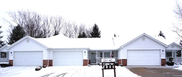 single story home with brick siding, covered porch, and an attached garage