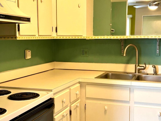 kitchen with light countertops, ventilation hood, electric range oven, and a sink