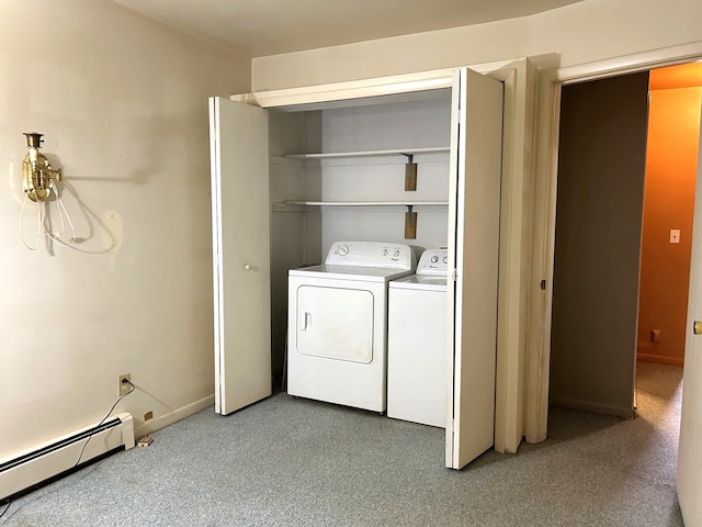 laundry room with a baseboard heating unit, laundry area, baseboards, and washer and clothes dryer