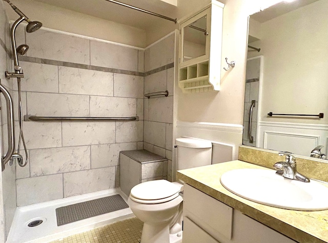 full bathroom featuring toilet, a stall shower, and vanity