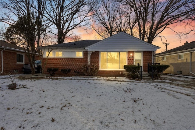 view of snow covered back of property