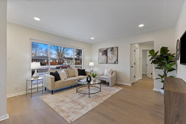 living area with recessed lighting, baseboards, and wood finished floors