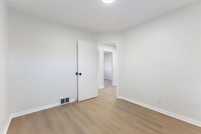 unfurnished room with visible vents, baseboards, and light wood-style flooring