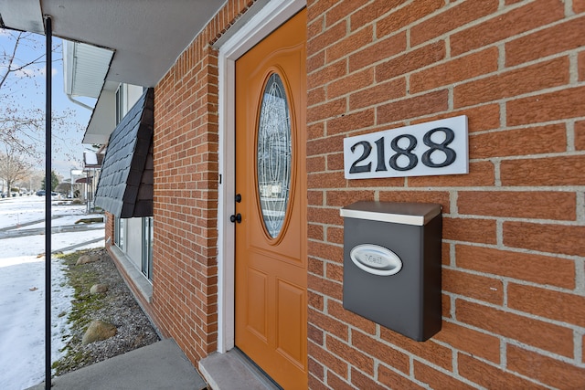 view of snow covered property entrance