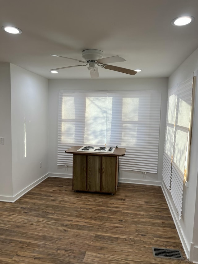 interior space with dark wood-type flooring and ceiling fan