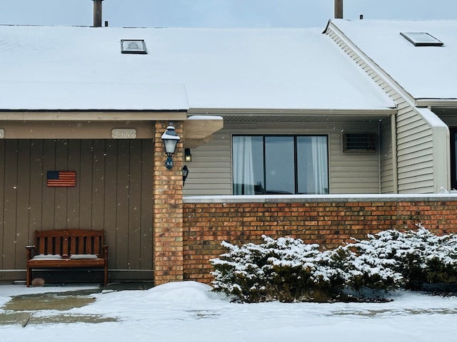 view of snow covered property entrance