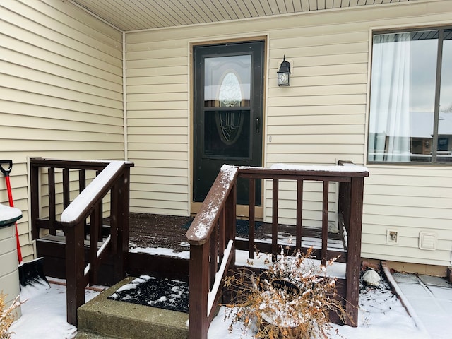 view of snow covered property entrance