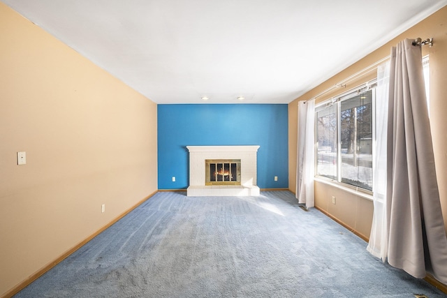 unfurnished living room featuring carpet floors and a tile fireplace