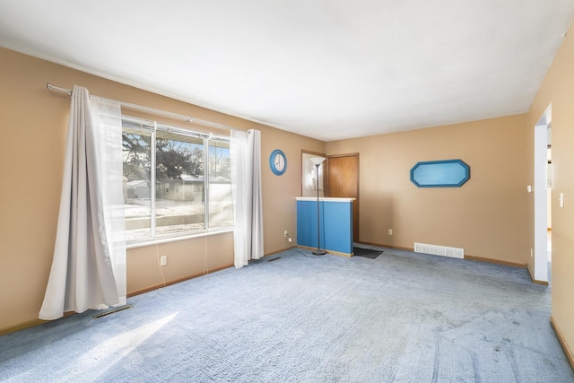 unfurnished room featuring light colored carpet