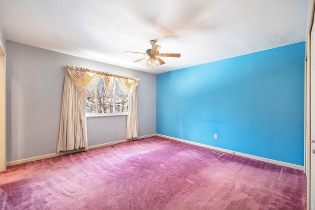 carpeted empty room featuring ceiling fan