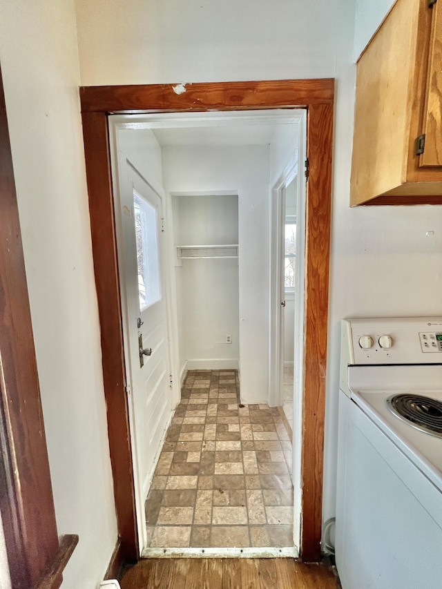 clothes washing area featuring cabinets