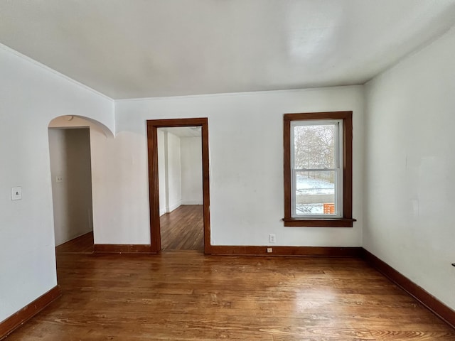 empty room with dark hardwood / wood-style flooring