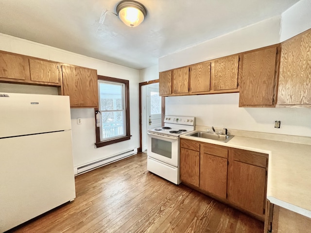 kitchen featuring wood-type flooring, baseboard heating, white appliances, and sink