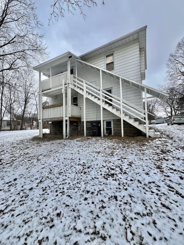 view of snow covered exterior with a balcony