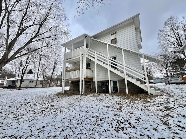 snow covered property with a balcony