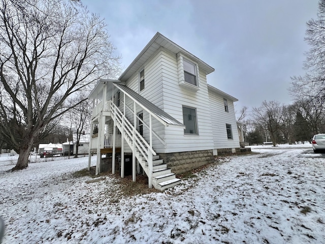 view of snow covered rear of property