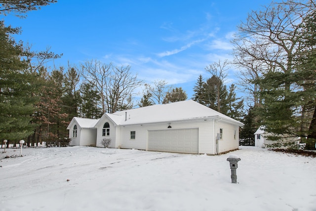 view of snow covered exterior with a garage