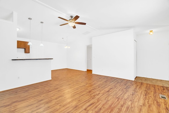 unfurnished living room featuring ceiling fan and light wood-type flooring