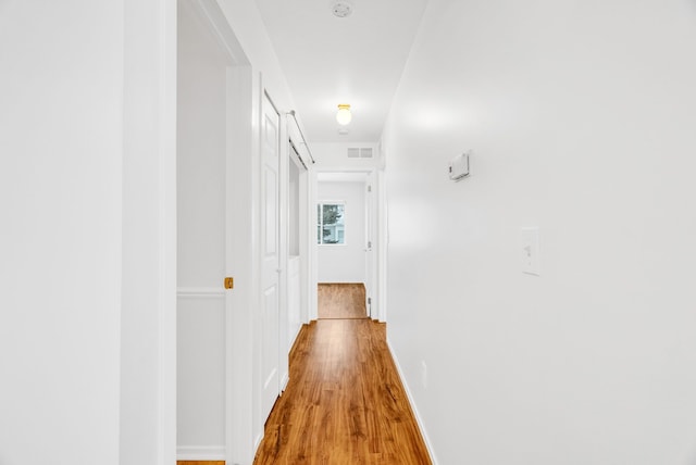 hall with hardwood / wood-style floors