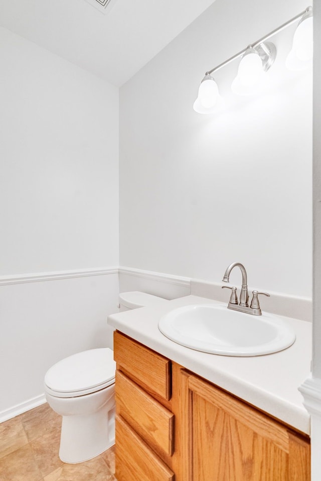 bathroom featuring vanity and toilet