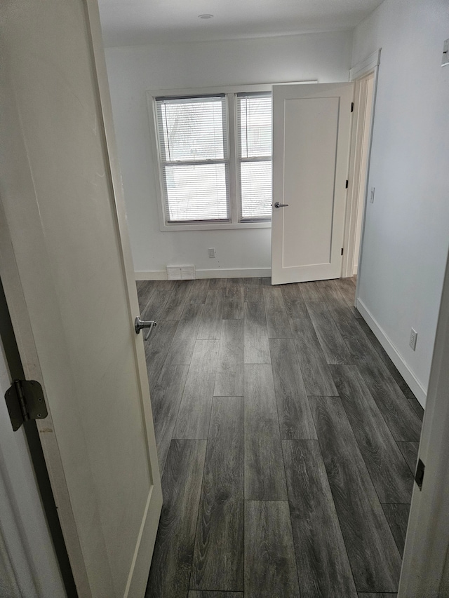 empty room with dark wood-type flooring