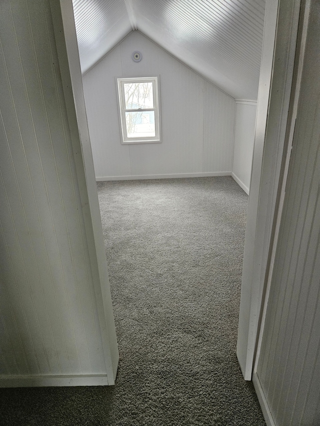 bonus room with vaulted ceiling and carpet flooring