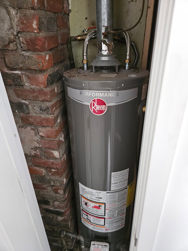 utility room featuring gas water heater