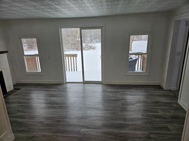 interior space featuring dark wood-type flooring and a fireplace