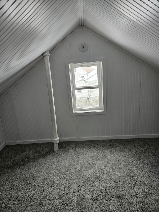 bonus room with carpet floors and vaulted ceiling