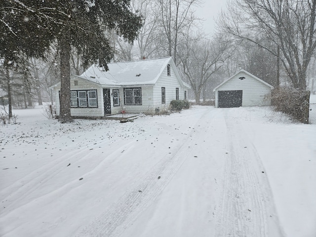 view of front of property featuring a garage and an outbuilding