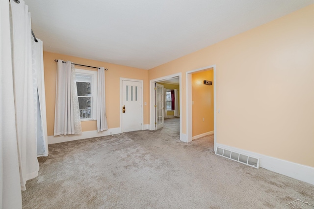 spare room with light colored carpet