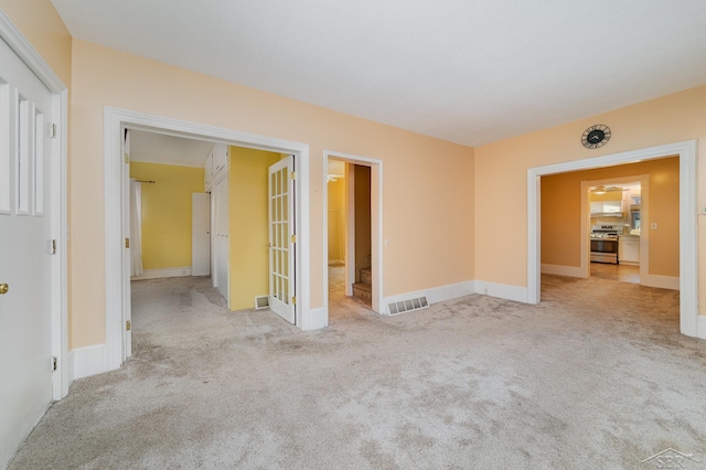 carpeted empty room with french doors