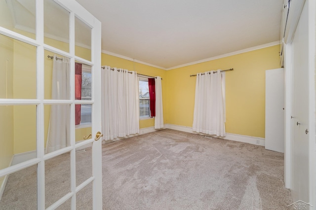 unfurnished room with light colored carpet, ornamental molding, and french doors