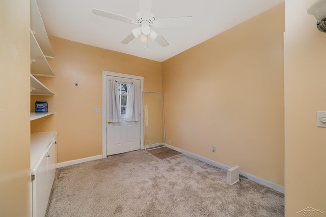 spare room with light carpet and ceiling fan