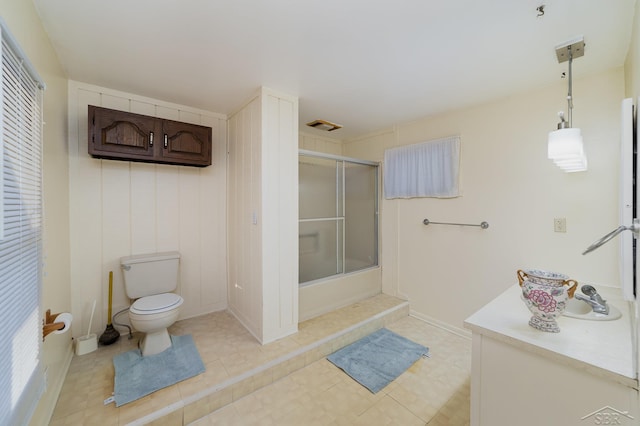 bathroom featuring toilet, tile patterned flooring, and vanity