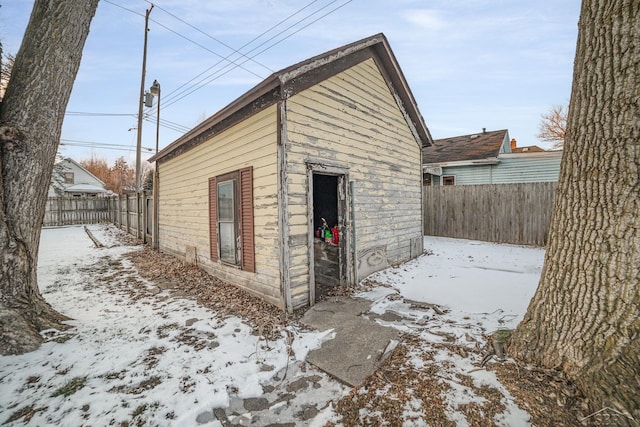 view of snowy exterior with an outdoor structure