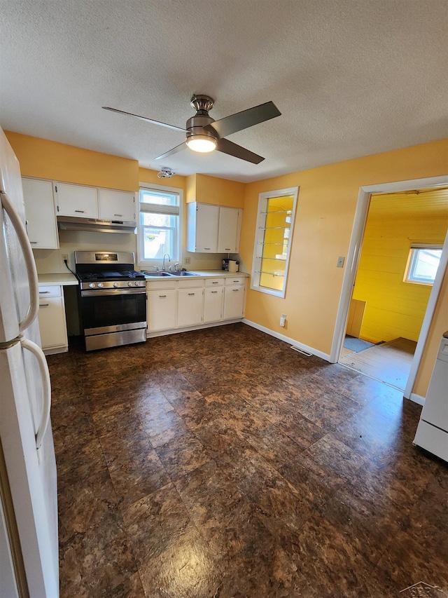 1454 Vermont St, Saginaw, MI 48602 - kitchen with ceiling fan, stainless steel range with gas stovetop, light countertops, and freestanding refrigerator