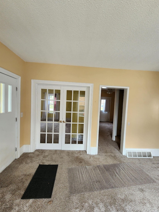 1454 Vermont St, Saginaw, MI 48602 - interior space with baseboards, french doors, a textured ceiling, carpet floors, and visible vents