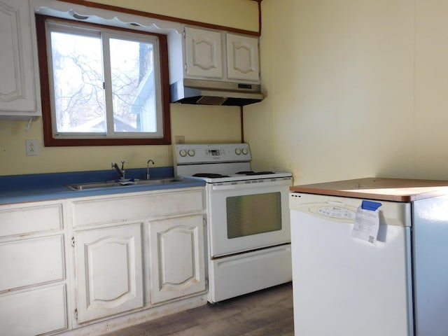 kitchen featuring dark hardwood / wood-style floors, sink, white cabinets, and white appliances