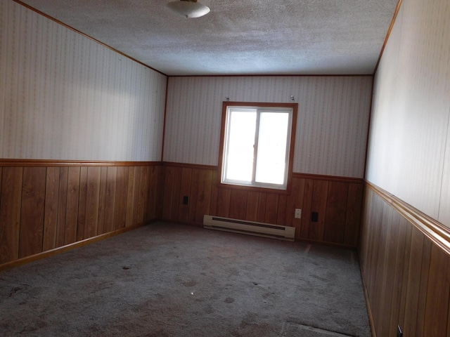 empty room with light colored carpet, a baseboard heating unit, and ornamental molding