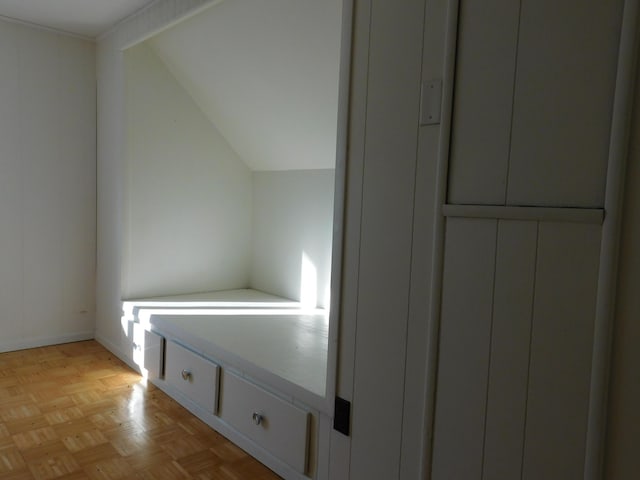 additional living space with lofted ceiling and light parquet flooring