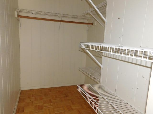 walk in closet featuring light parquet flooring