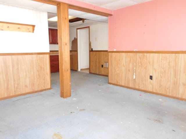 basement featuring wooden walls