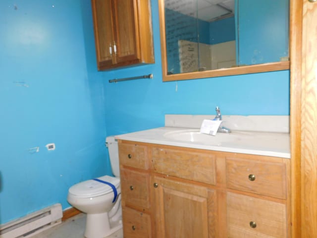 bathroom with toilet, baseboard heating, and vanity