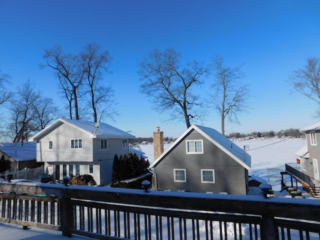 view of snow covered rear of property