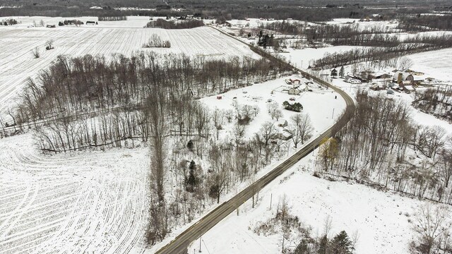 snowy aerial view featuring a rural view