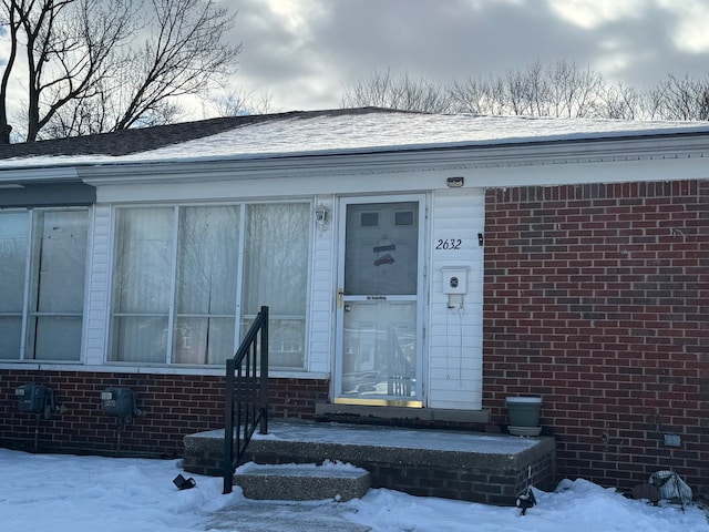 view of snow covered property entrance