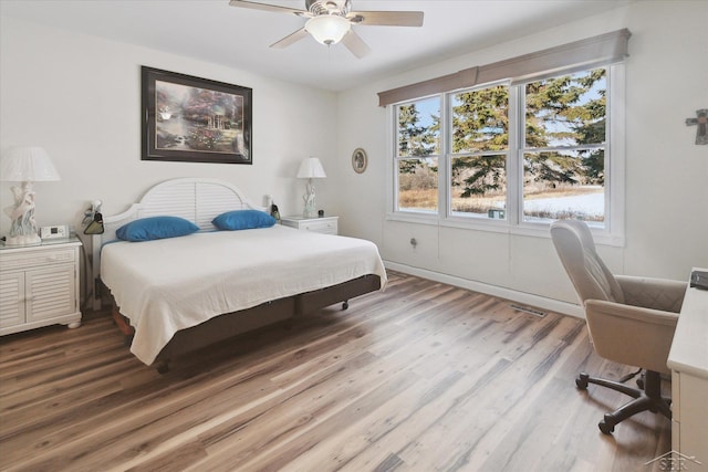 bedroom with ceiling fan and hardwood / wood-style flooring