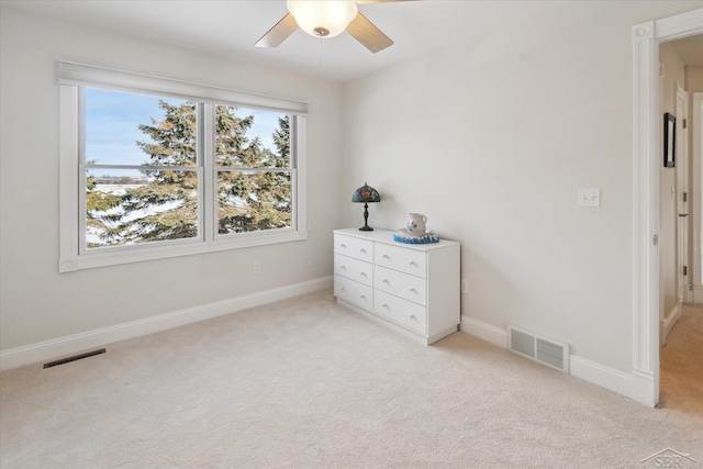 unfurnished bedroom featuring ceiling fan and light carpet